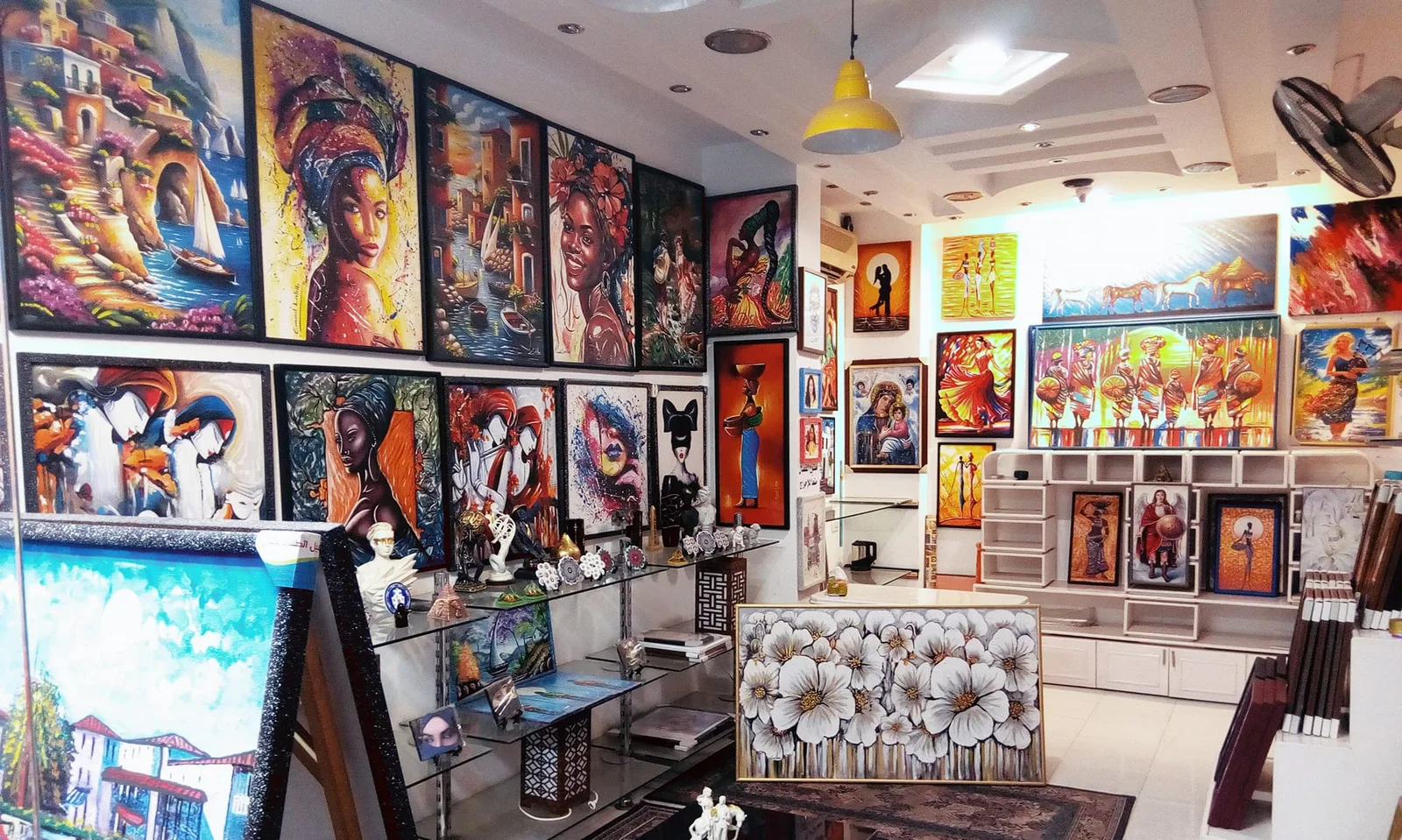 Inside La Boutique Art gallery in Hurghada, paintings by Emad Labib hanging across the walls